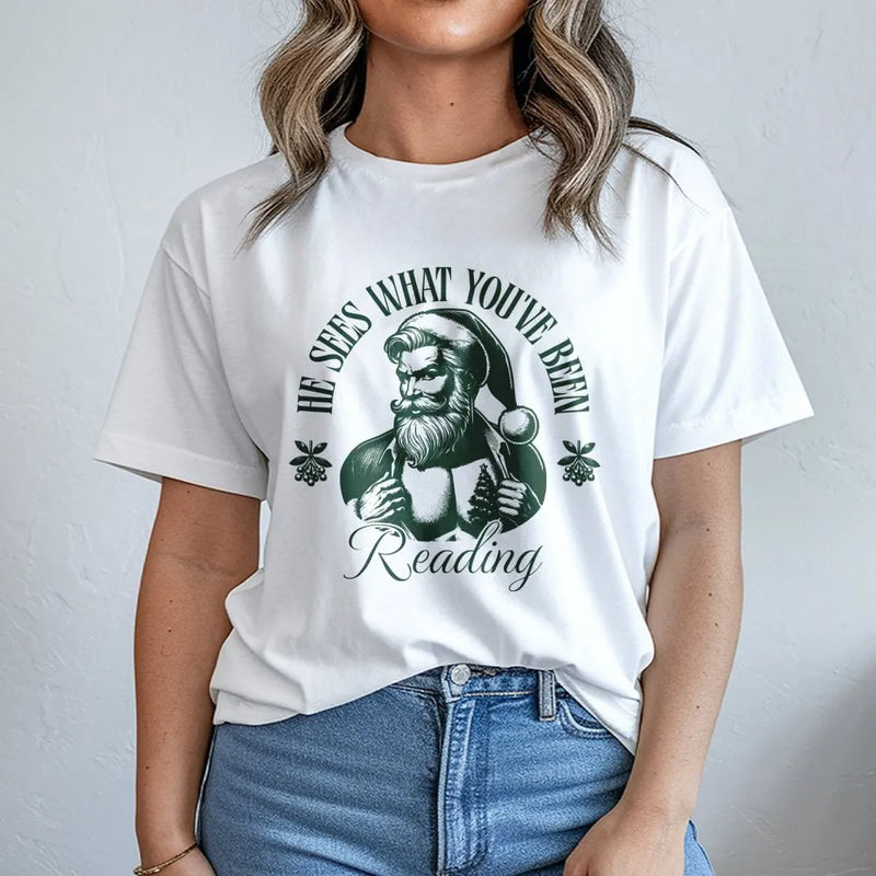 Humorous Santa Book Lover T-Shirt, He Sees What You've Been Reading T-Shirt, Bookish Christmas Shirt, Holiday Reader Graphic Tee, Bookworm Present